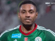 a soccer player wearing a green and white jersey with a blue sticker that says ' certified club '