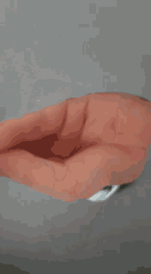 a close up of a person 's hand with a ring around it