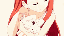 a girl with long red hair is holding a stuffed bunny