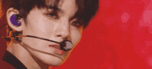 a close up of a person 's face with a microphone in their ear