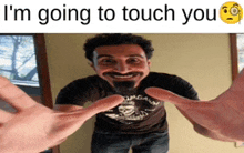 a man with a beard is being touched by someone 's hands with the caption i 'm going to touch you