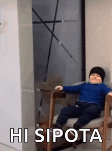 a little boy is sitting in a chair with the words hi sipota written on the bottom