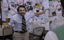a man in a suit and tie is standing in front of a wall with papers on it .