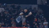 a wrestler is laying on his stomach in a boxing ring .