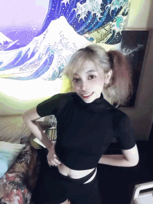 a girl stands in front of a painting of waves on the wall