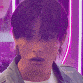 a close up of a young man 's face with a purple background