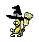 the banana is wearing a witch hat and holding a broom .