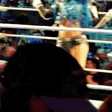 a blurred image of a woman in a boxing ring with the hashtag #thenextbigthing