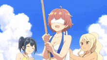 a girl in a bikini is holding a stick in her hand