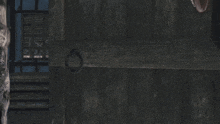 a woman with a tattoo on her face is standing in front of a wall with a grid pattern
