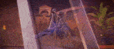 a person is holding a sword in their hand in a dark room .