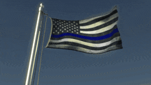a flag with a blue stripe on it is waving in the wind
