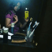 a woman taking a picture of herself in a mirror