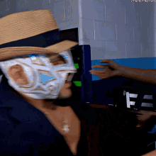 a man wearing a mask and a hat has the hashtag #thenextthing written on the bottom