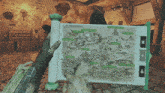 a person is holding a map that says the forsaken lands on it