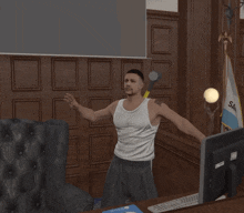 a man in a white tank top is standing in front of a computer and a flag that says sa