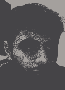 a black and white image of a man 's face