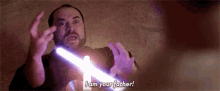 a man is holding a light saber and saying `` i am your father ! ''