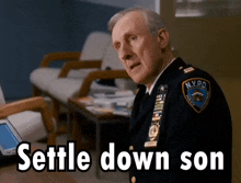 a man in a nypd uniform is sitting at a table