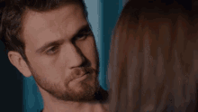 a man touches a woman 's forehead in a close up
