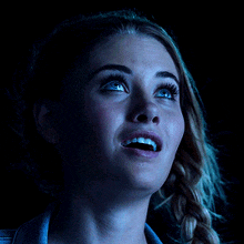 a close up of a woman 's face with blue eyes
