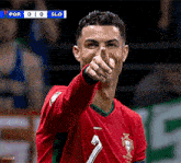 a soccer player with the number 7 on his jersey is giving the thumbs up