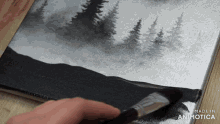 a person is painting a black and white landscape with the words made in animatica below