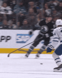 a hockey game is being played in front of a sap sign