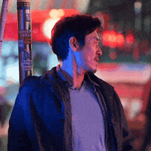 a man stands in front of a pole with a sticker on it that says 2499888