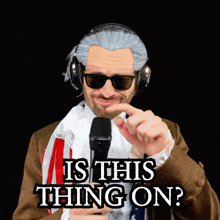 a man wearing headphones and sunglasses holds a microphone and says " is this thing on " in black letters