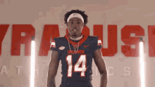 a football player wearing a blue jersey with the number 14 on it