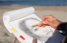 a person is drawing a portrait of a woman with a yellow pencil