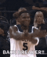 a man in a basketball uniform is giving a thumbs up and saying `` back breaker ! ''