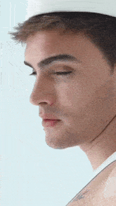 a close up of a man 's face with a hat on