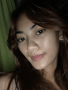 a close up of a woman 's face with brown hair