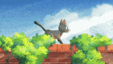 a cat is walking across a brick wall surrounded by greenery