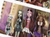 a group of monster high dolls standing next to each other on a shelf