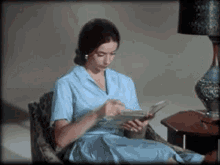 Woman Reading Baby GIF - Woman Reading Baby Cradle GIFs
