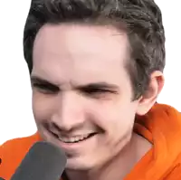 a man in an orange hoodie is smiling while holding a microphone