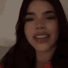 a close up of a woman 's face with her mouth wide open .