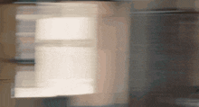 a blurred image of a person standing in front of a light