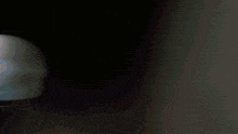 a white light is shining through a dark tunnel