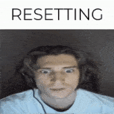 a picture of a man with headphones and the word resetting below it
