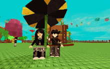 a girl and a boy are standing next to a large black flower