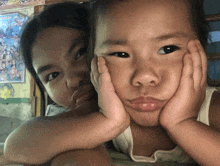 a little girl and a little boy are posing for a picture