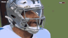 a close up of a football player wearing a helmet that says cowboys
