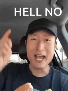 a man in a car says hell no while holding a hamburger