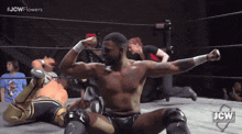a man in a wrestling ring with the jcw logo on the bottom right