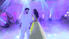 a man and a woman are dancing together on a stage