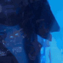 a blurry picture of a person in a dark room with blue lights